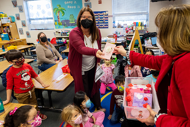 Teacher receiving a Valentines card from the school's principal. 
