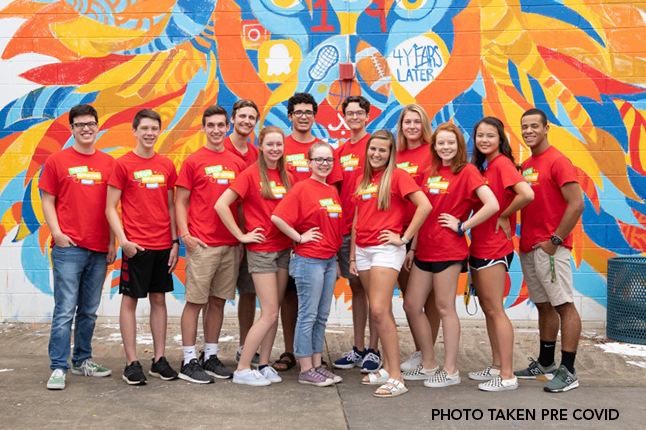 Photo of a group of teenagers wearing match red shirts. 
