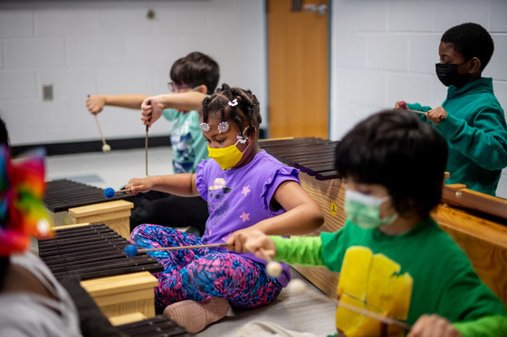second grade musicians play the xylophone 