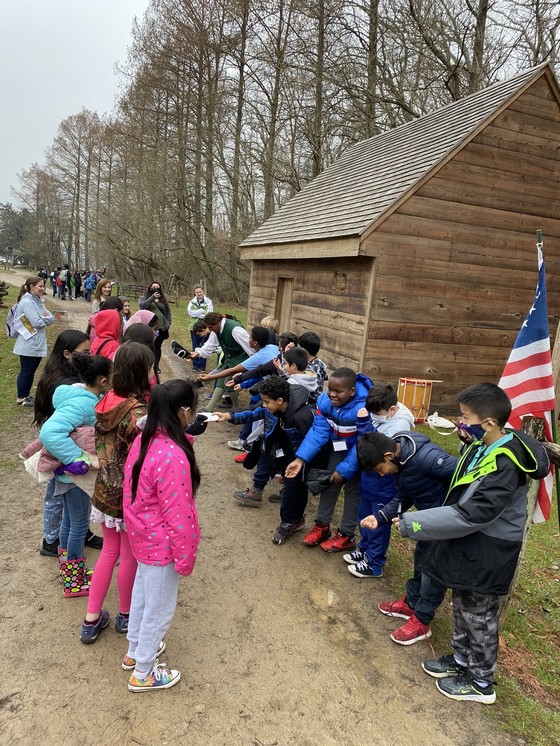 Photo of a line of children bowing