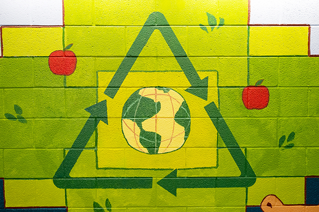 Wall painting of the recycling logo. 