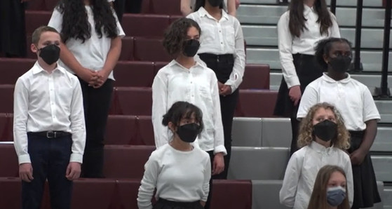 Sixth grade students singing at a choir concert. 