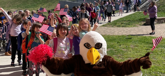 Ernie the Eagle leads military connected students through the hallways. 