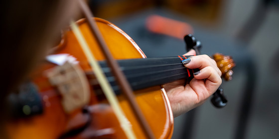 Close up of someone playing a violin.