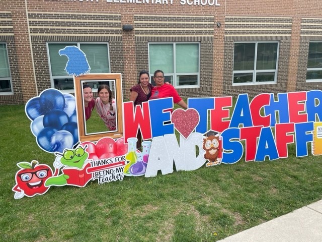 Clermont staff pose with the teacher appreciation week sign. 
