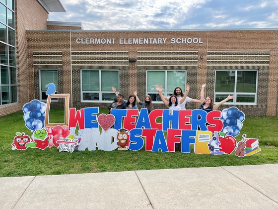 Clermont staff pose with the teacher appreciation sign. 