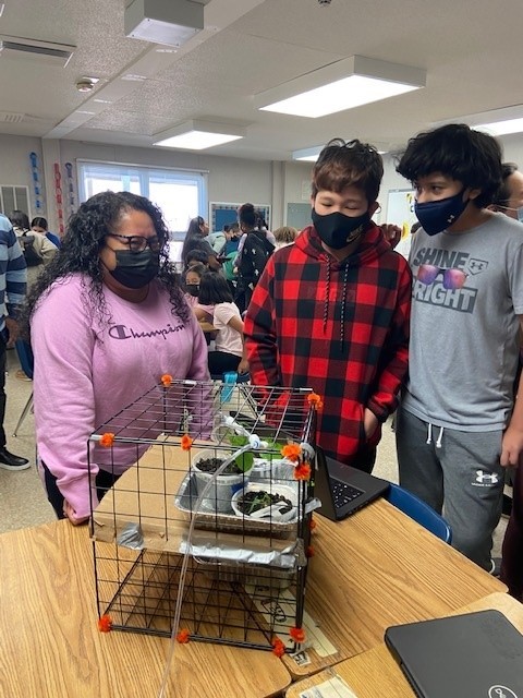 Students in the Engineering Club showcase their sustainable gardens to parents.