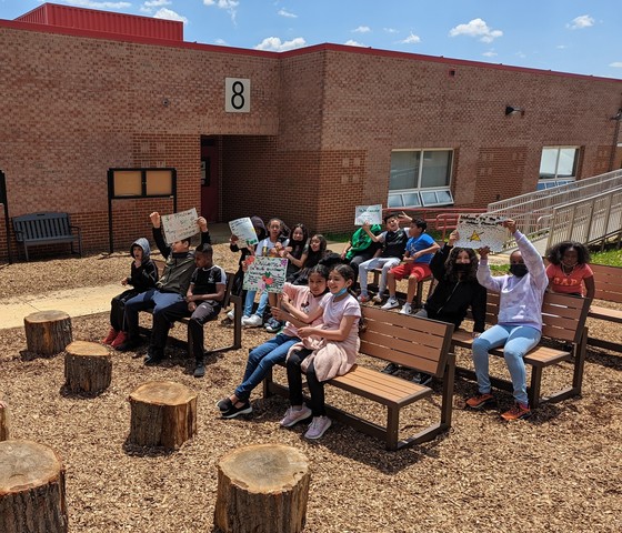 Photo of students sitting in the outdoor classroom
