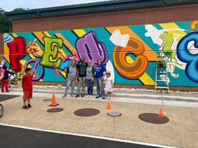 Melanie Meren with Dogwood staff and community members in front of mural