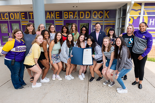 Picture of Lake Braddock Secondary School gymnastics team with staff, school board members, and Delegates Eileen Filler-Corn and Dan Helmer.