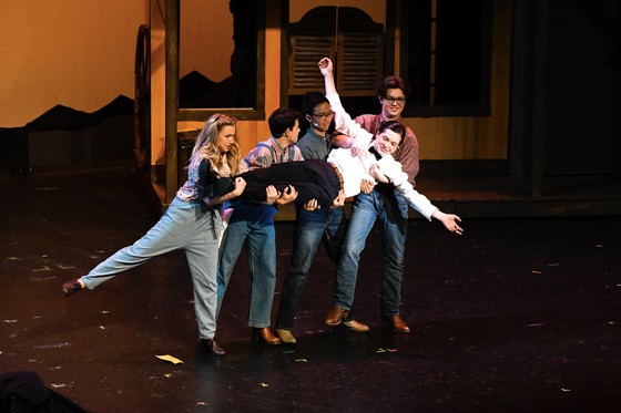 Students dance in a high school theatre production. 