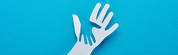 A white paper hand with the shape of a hand cut out of it over a blue background. 