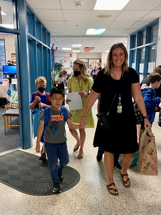 Student and teacher walking down hall