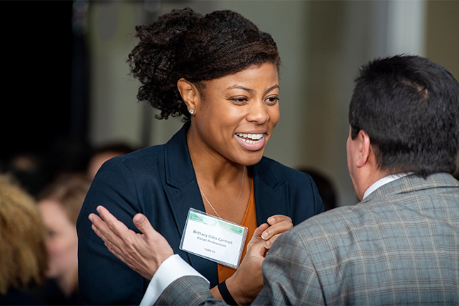 Two community leaders networking at a public event.  Networking is a measurable element of partnering.