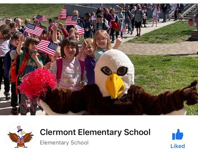 A image of Clermont Elementary's facebook page, with Ernie the Eagle leading a group of children on parade.