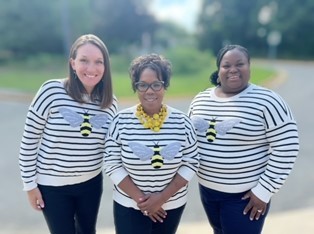 phto of admin team in matching bee sweaters