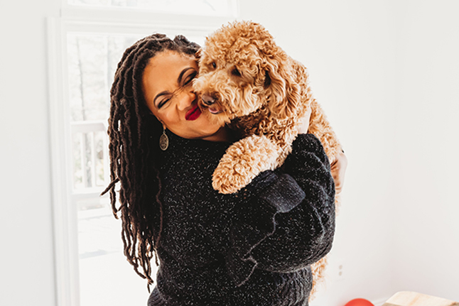 Rashida Green gives kisses to her dog, Willow Wiggles, a goldendoodle