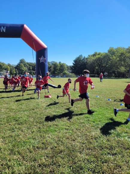 An image shows students running at the Boosterthon Fun Run 