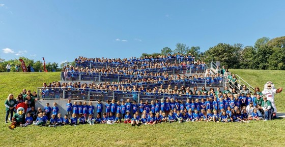 A group photo of the students and staff of Clermont on the stairs leading to the upper field.