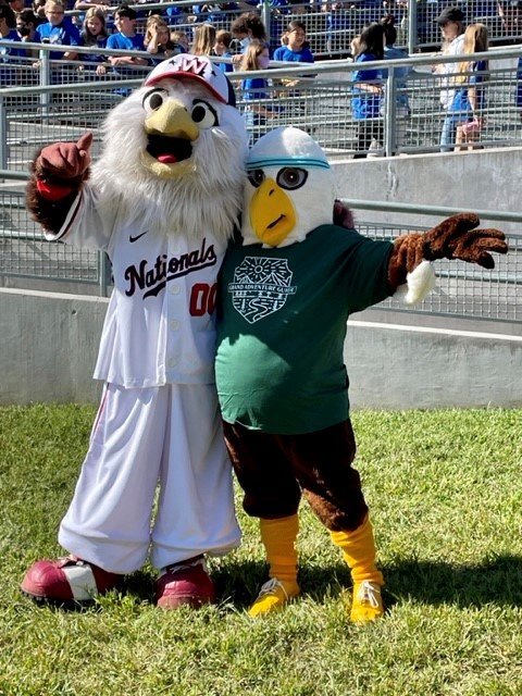Screech, Washington Nationals Mascot, and Clermont's Ernie the Eagle pose together outside.