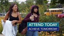Two girls walk into school. "Attend Today Achieve Tomorrow