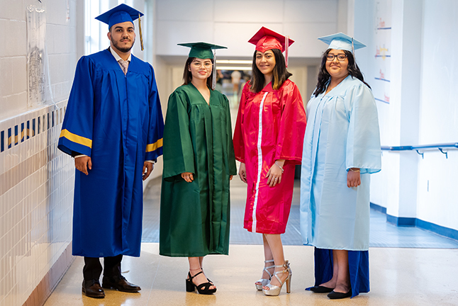 Four students in graduation robes