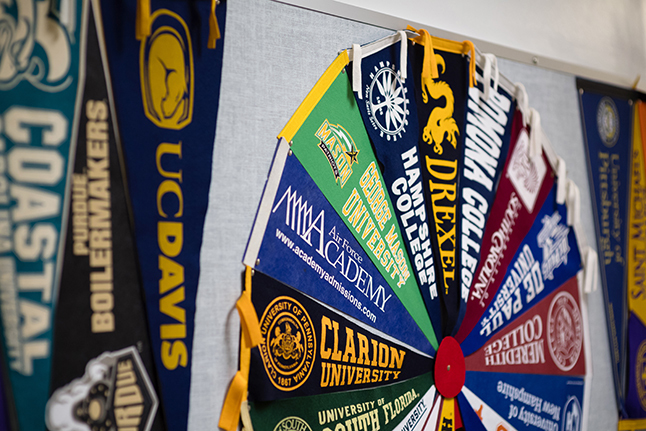 College pennants hang on a wall