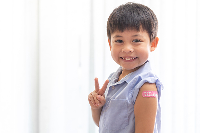 Smiling child with band aid
