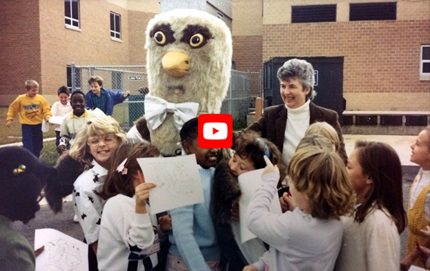 Old photo of first Silverbrook Elementary principal with students and mascot.