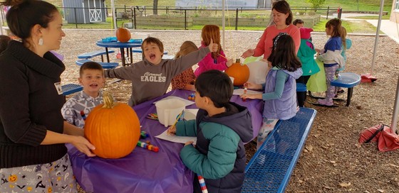 Students in Mrs. Collier's class carve pumpkins during Pumpkin Math
