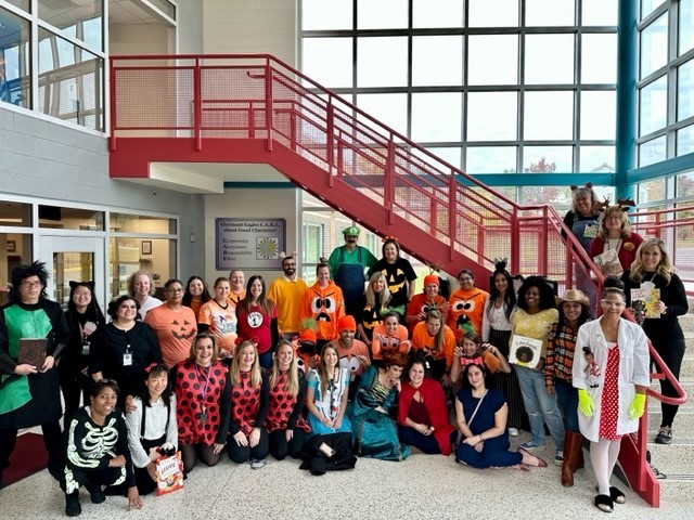 Clermont staff pose for a group picture in their book character costumes.