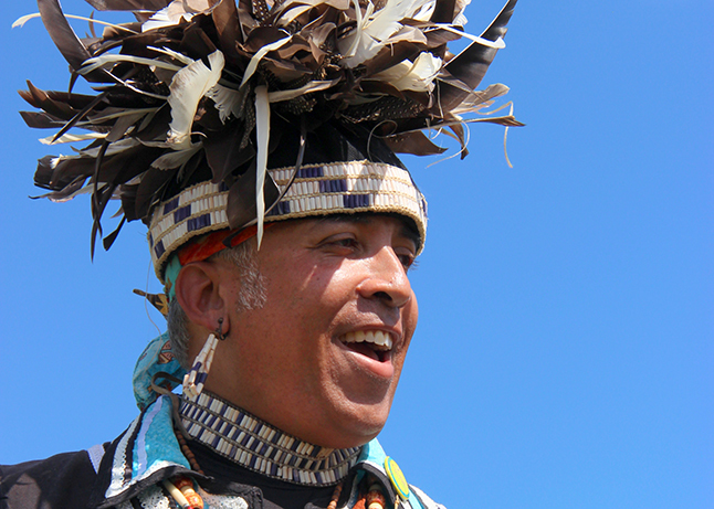 Smiling man with feather headdress