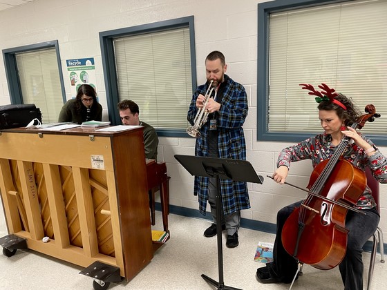 Music teachers playing instruments in the hallway