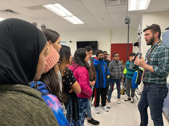 A group of students watches as a teacher conducts a presentation about quantum physics at Thomas Jefferson High School