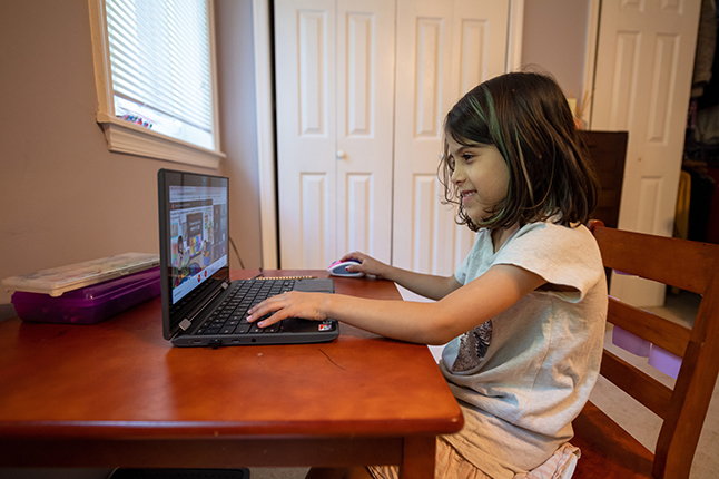 A student at a laptop receiving virtual tutoring through our Ignite Partnership with EduTutorVA.