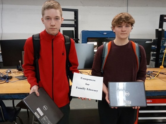 Two Chantilly Academy students who helped refurbish laptop computers. 
