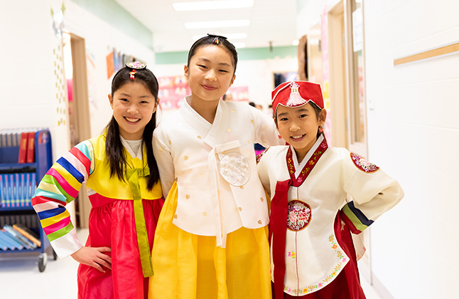 Students smiling in traditional Korean clothing