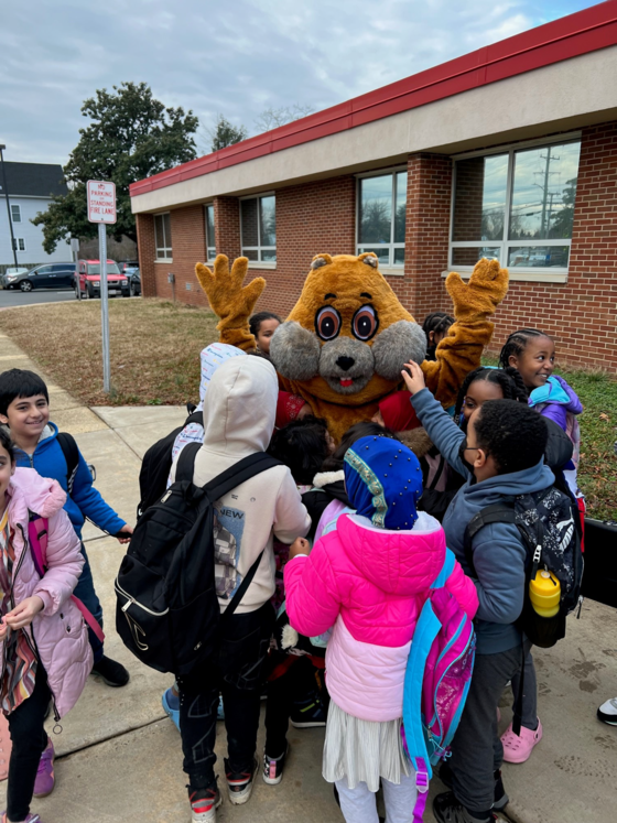 Photo of the school mascot greeting students in front of Weyanoke