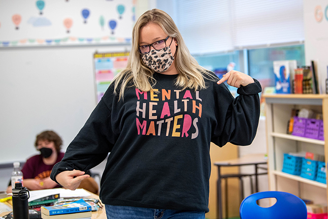 Teacher showing "Mental Health Matters" sweatshirt