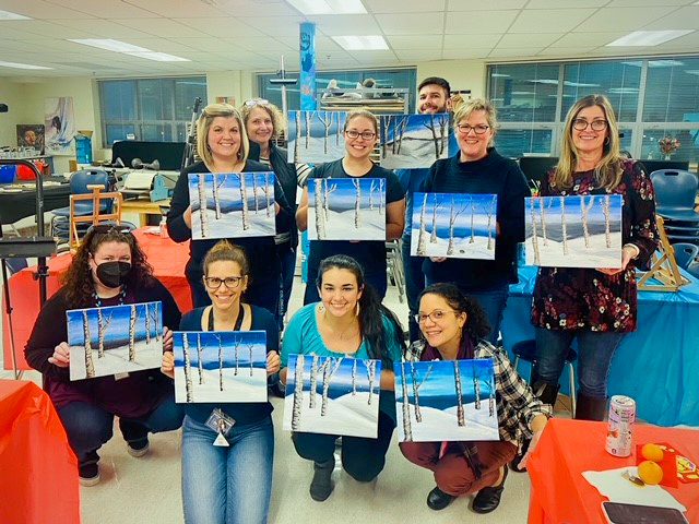 Teachers with their pictures after the Winter Paint Party