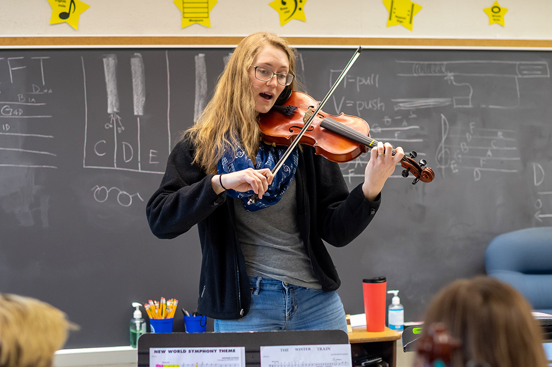 Teacher playing violin