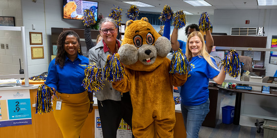 Ms. Usher, Dr. Reid, Woody the Woodchuck Ms Hughey, Ms. Walsh and Ms. Alfaro posing on Woodchuck Day