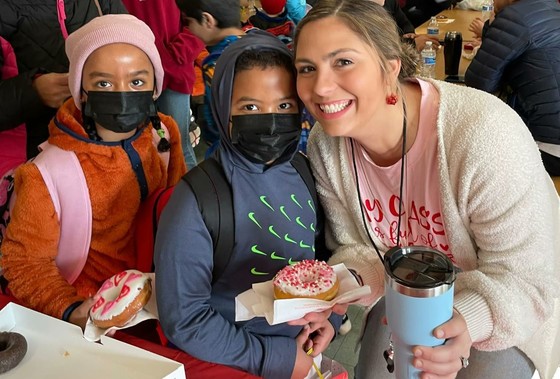 teacher with two kids and donuts