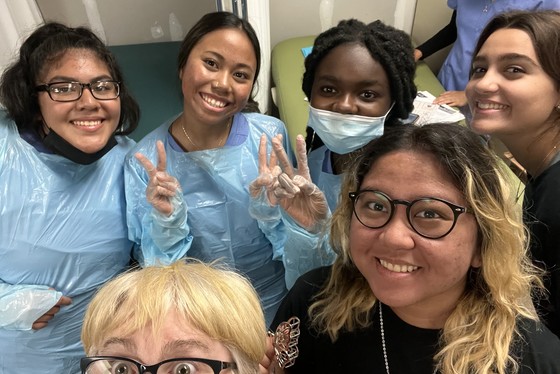Students in scrubs and gowns
