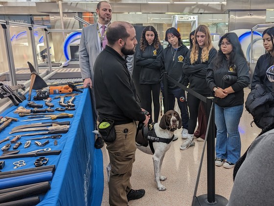 TSA dog and handler with items seized