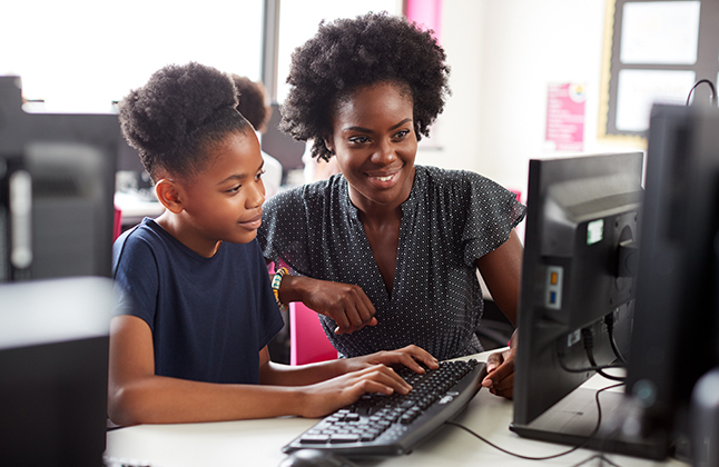 Tutor on computer with student