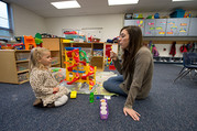 teacher blowing bubbles for student