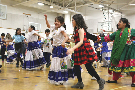 Photo of students dancing in cultural clothing at International Night.