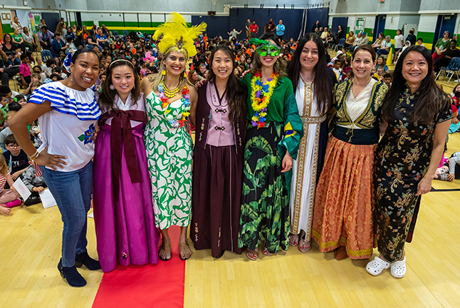 School staff at world showcase day fashion show