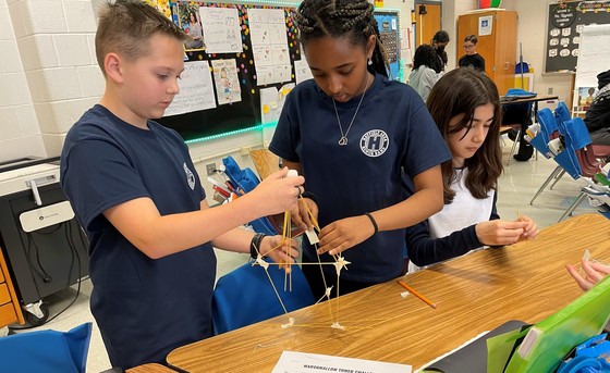 Students building marshallow-spaghetti towers in STEAM